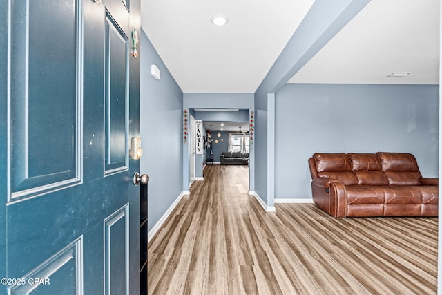 entryway featuring visible vents, baseboards, and wood finished floors