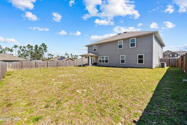 back of house with a lawn, cooling unit, and a fenced backyard