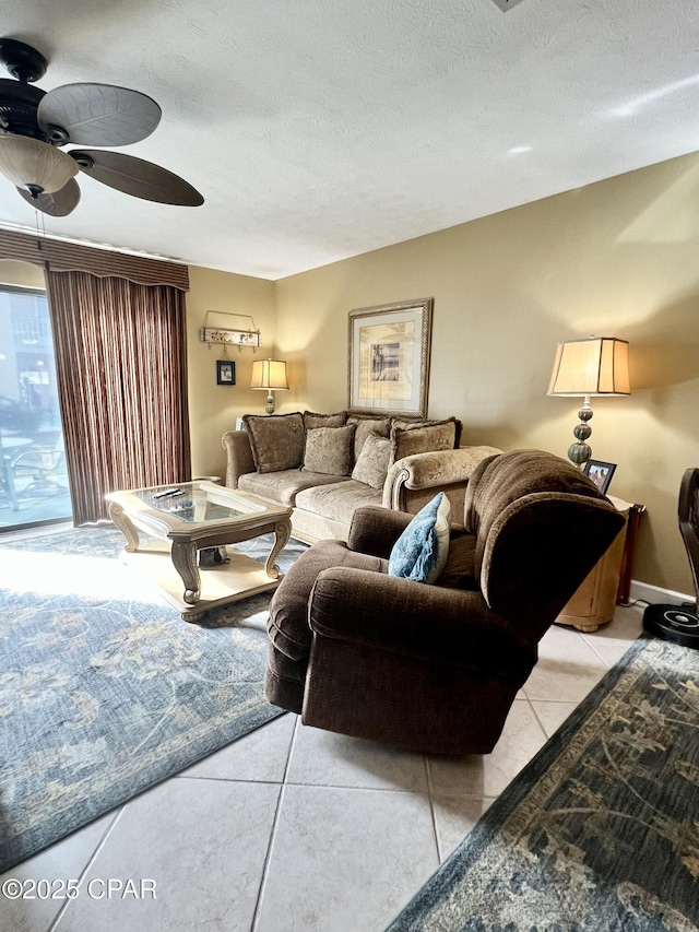 living room featuring light tile patterned floors, a textured ceiling, and a ceiling fan