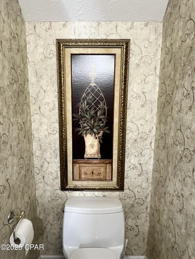 bathroom with a textured ceiling and toilet