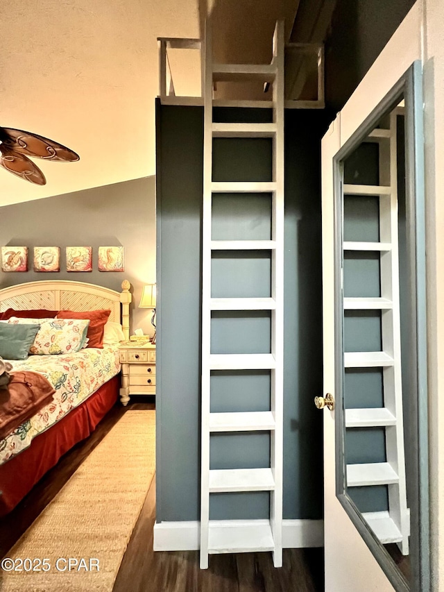 bedroom with wood finished floors and baseboards