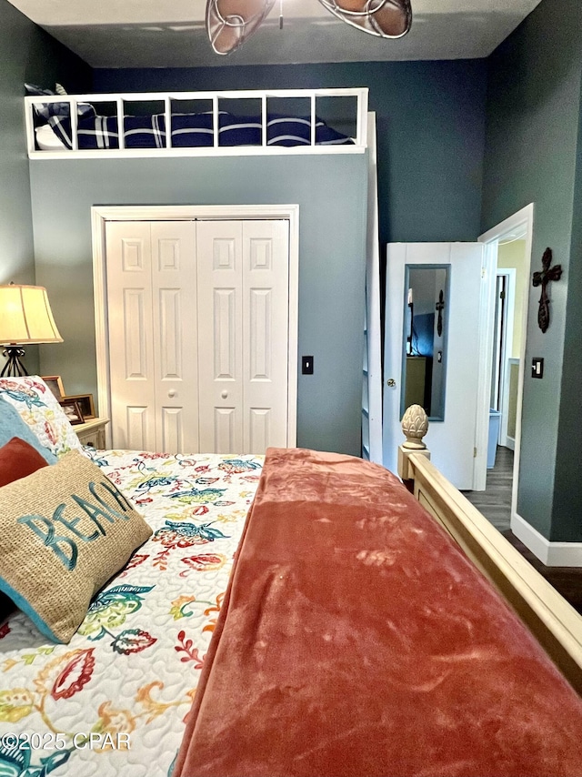 bedroom with baseboards and a closet