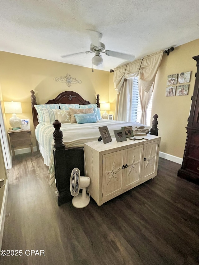 bedroom with dark wood-style floors, ceiling fan, a textured ceiling, and baseboards