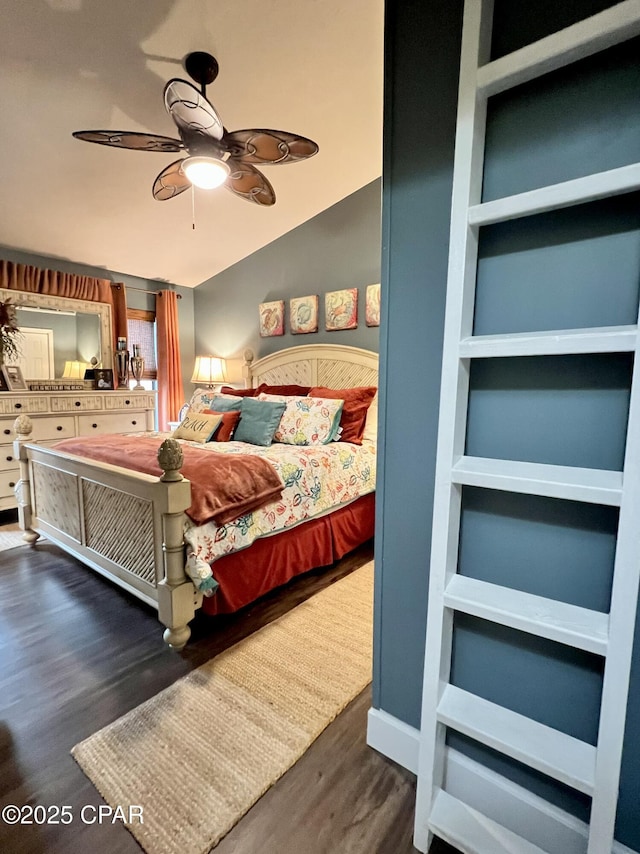 bedroom featuring lofted ceiling and wood finished floors