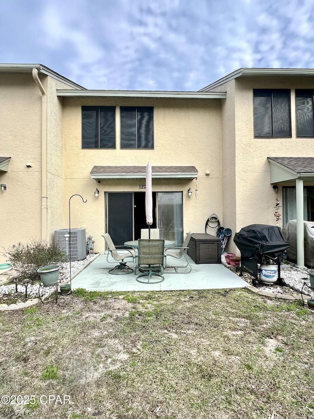 back of property featuring central air condition unit, a patio, and stucco siding