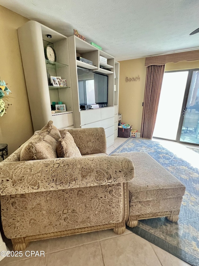 living room featuring a textured ceiling and tile patterned floors