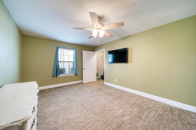 unfurnished bedroom with carpet, a ceiling fan, and baseboards