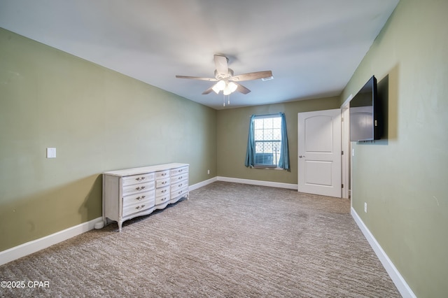 unfurnished bedroom with carpet flooring, a ceiling fan, and baseboards