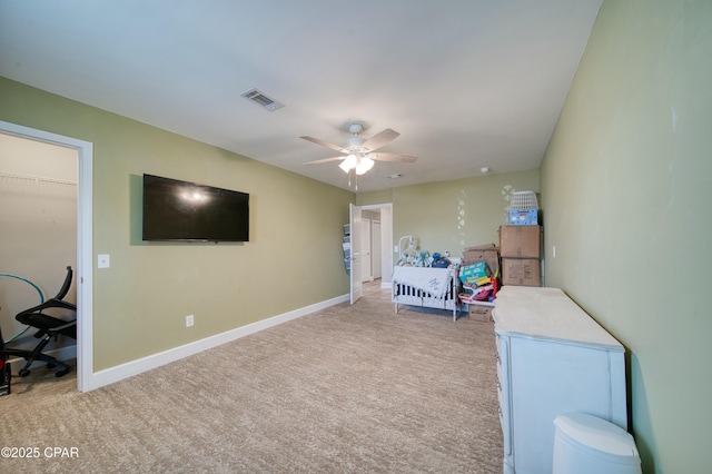 bedroom featuring light carpet, ceiling fan, visible vents, and baseboards