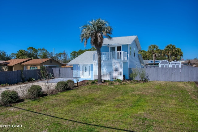 back of property with fence and a yard