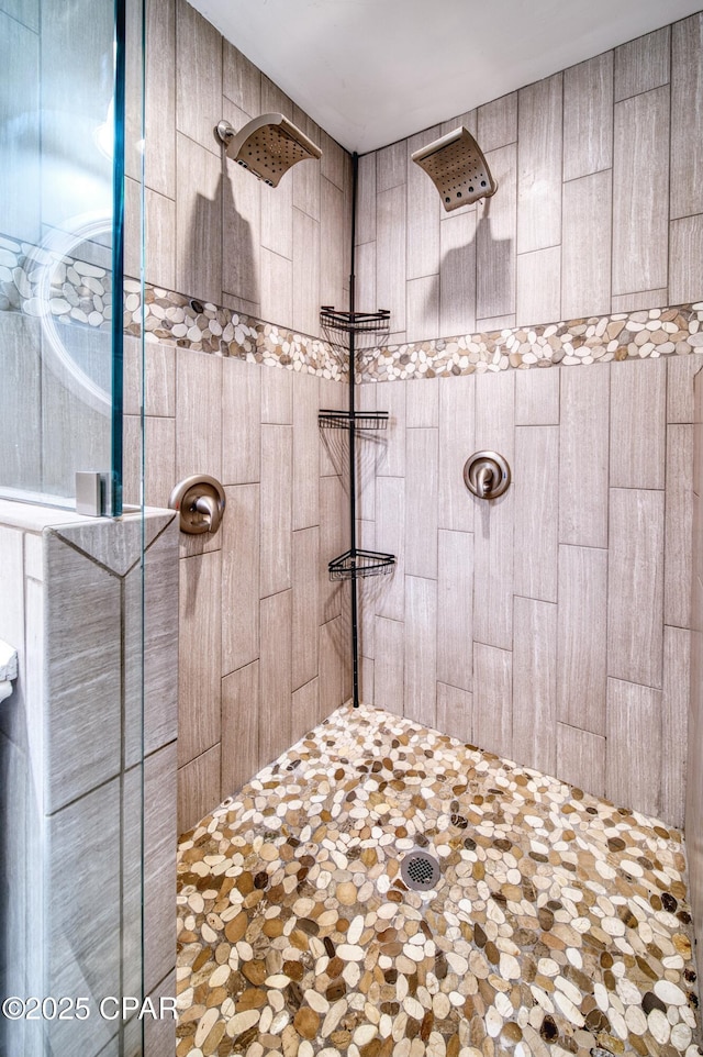 bathroom with a tile shower