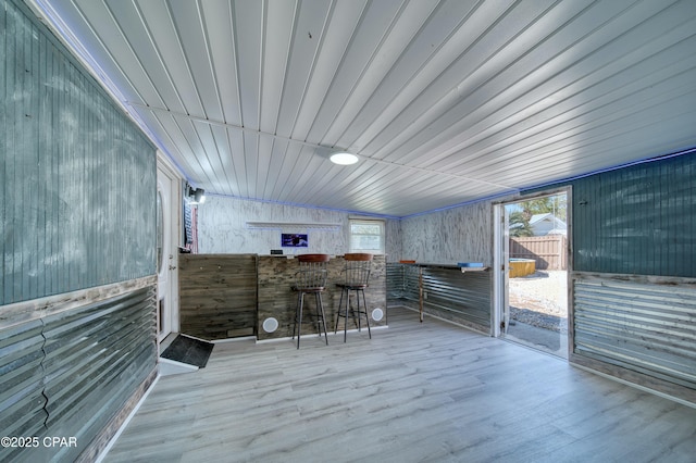 interior space with a dry bar and wood finished floors