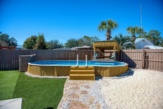 view of pool with a fenced in pool, a fenced backyard, and a yard