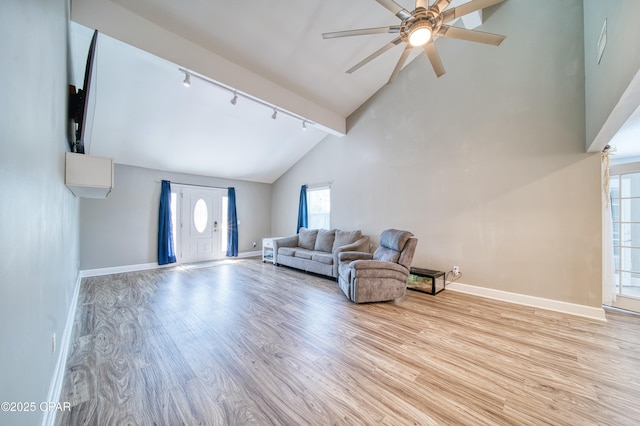 living room featuring high vaulted ceiling, ceiling fan, baseboards, and wood finished floors