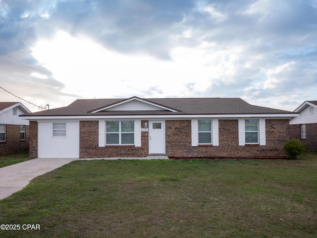 ranch-style home with brick siding, a front yard, and a shingled roof