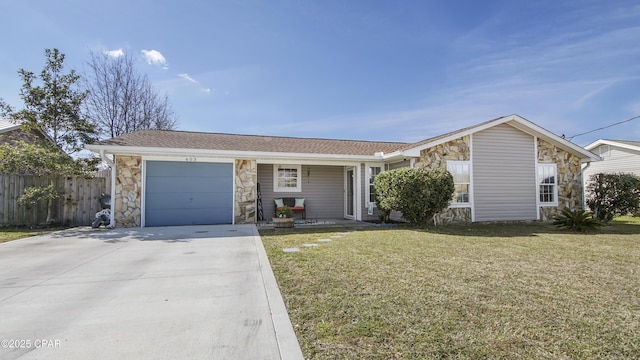 view of front of house featuring a garage, driveway, stone siding, fence, and a front yard