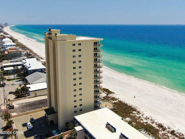 birds eye view of property featuring a view of the beach and a water view