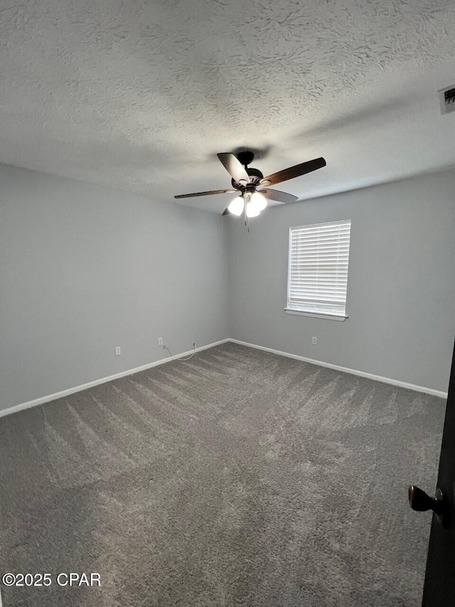 unfurnished room featuring dark carpet, a textured ceiling, baseboards, and ceiling fan