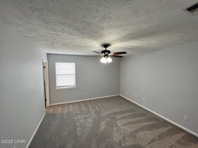 empty room with visible vents, a ceiling fan, baseboards, and dark colored carpet