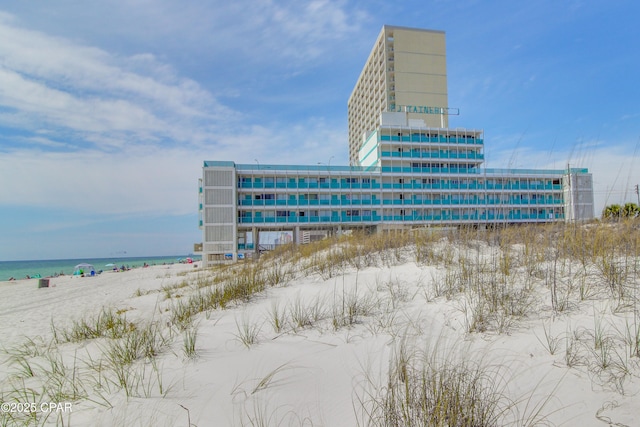 view of property featuring a water view and a view of the beach