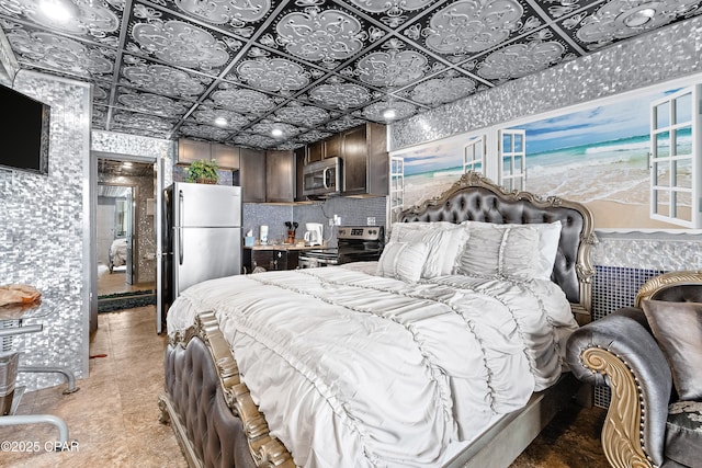 bedroom with freestanding refrigerator, an ornate ceiling, and wallpapered walls