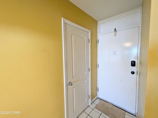 doorway to outside with light tile patterned floors