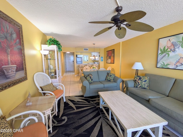 tiled living area with visible vents, ceiling fan, and a textured ceiling