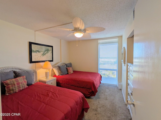 carpeted bedroom with a textured ceiling and a ceiling fan