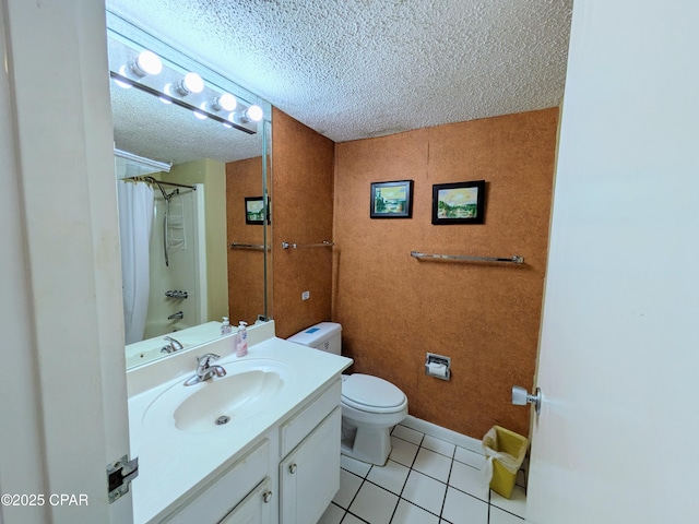 full bath with a textured ceiling, toilet, vanity, baseboards, and tile patterned floors