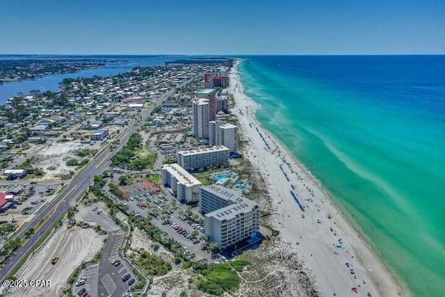 drone / aerial view with a water view, a city view, and a view of the beach