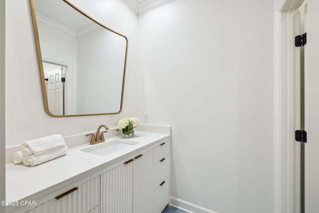 bathroom with baseboards, vanity, and crown molding