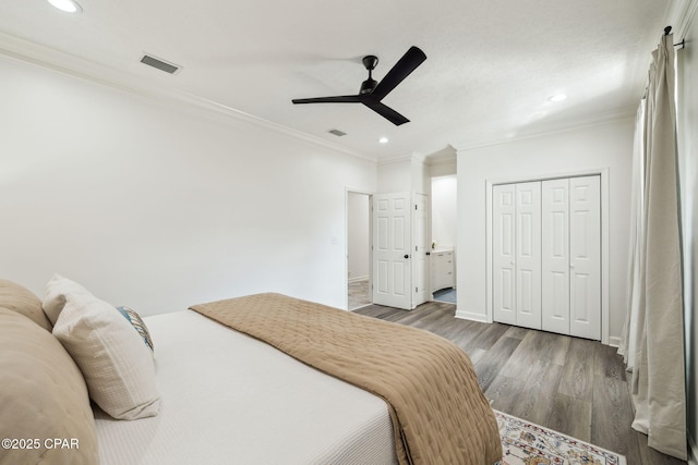 bedroom with recessed lighting, a closet, visible vents, ornamental molding, and wood finished floors