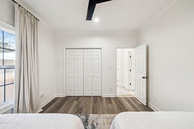 bedroom featuring ornamental molding, baseboards, and wood finished floors