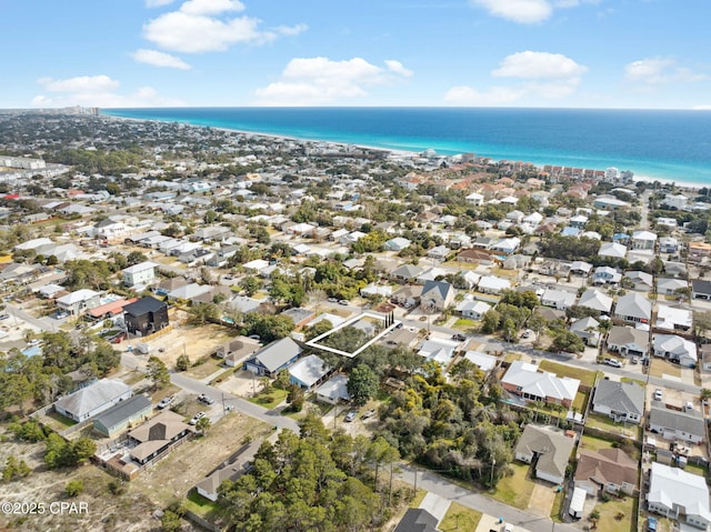 bird's eye view with a residential view, a water view, and a beach view