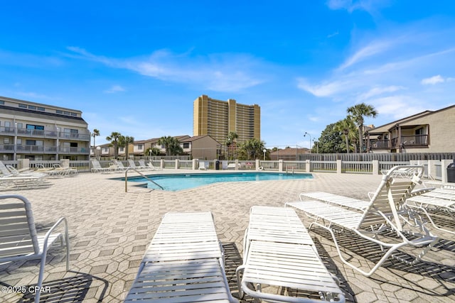 community pool featuring a patio and fence