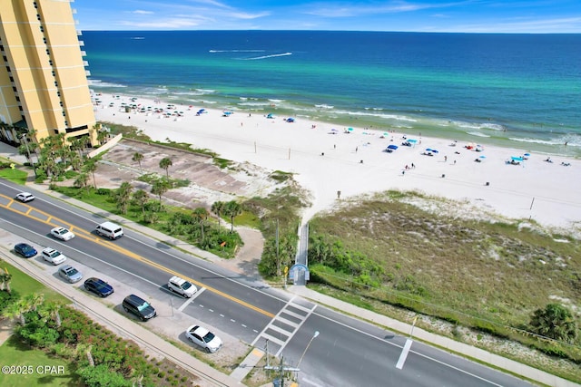 birds eye view of property featuring a beach view and a water view