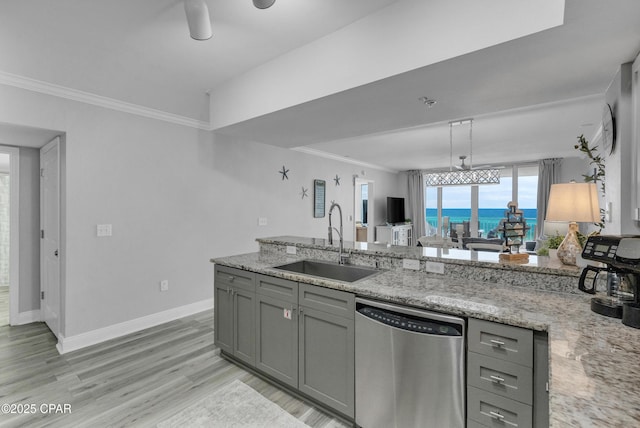 kitchen featuring crown molding, stainless steel dishwasher, a sink, and gray cabinetry