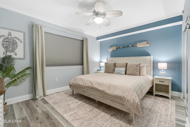 bedroom featuring ornamental molding, ceiling fan, baseboards, and wood finished floors