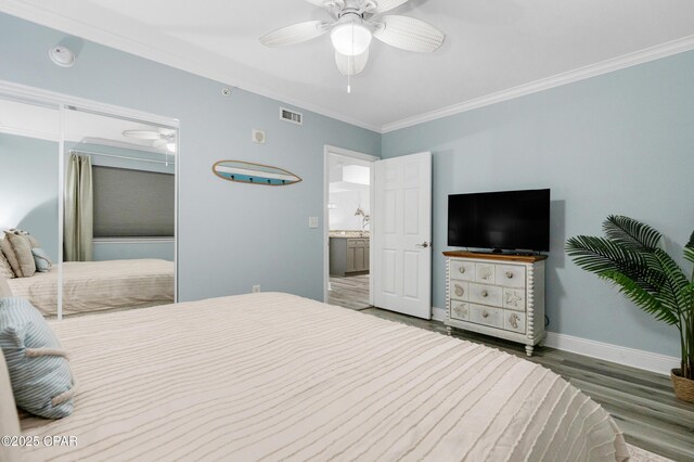 bedroom with visible vents, ornamental molding, ceiling fan, wood finished floors, and baseboards