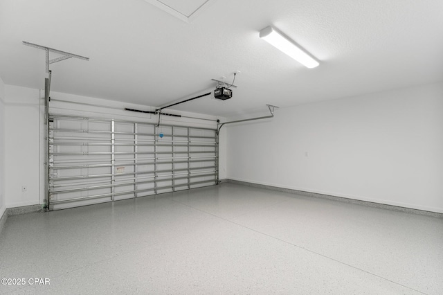 garage featuring a garage door opener and baseboards
