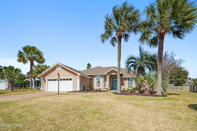 view of front facade with stucco siding, an attached garage, a front yard, fence, and driveway