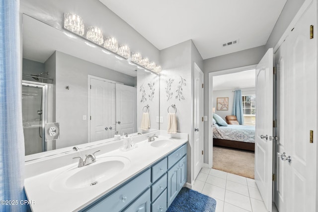 ensuite bathroom with a stall shower, tile patterned flooring, a sink, and visible vents