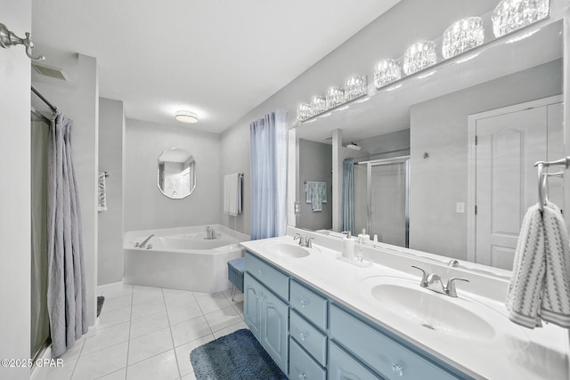 bathroom featuring a stall shower, tile patterned flooring, a garden tub, and a sink