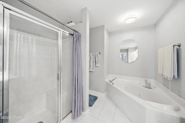 full bath featuring a stall shower, tile patterned flooring, and a jetted tub