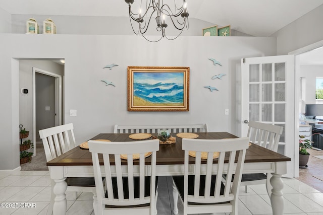 dining room featuring light tile patterned floors, a chandelier, and lofted ceiling