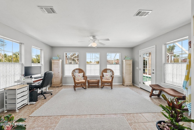 office space featuring a ceiling fan, visible vents, and baseboards