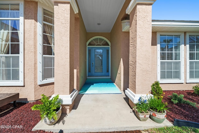 property entrance featuring stucco siding