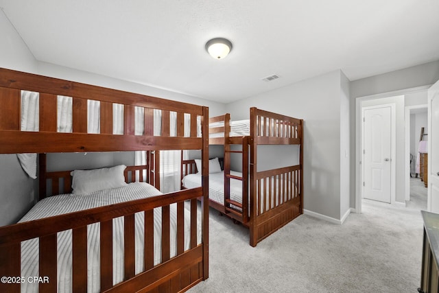 bedroom with light colored carpet, visible vents, and baseboards