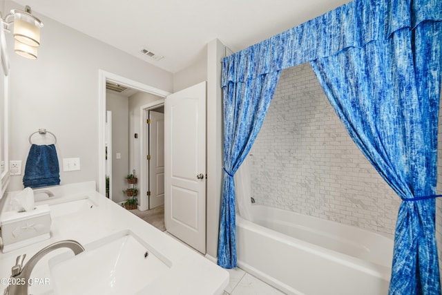 bathroom with shower / bathtub combination with curtain, visible vents, a sink, and tile patterned floors