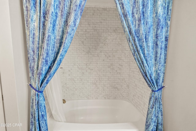 bathroom with shower / bath combo with shower curtain